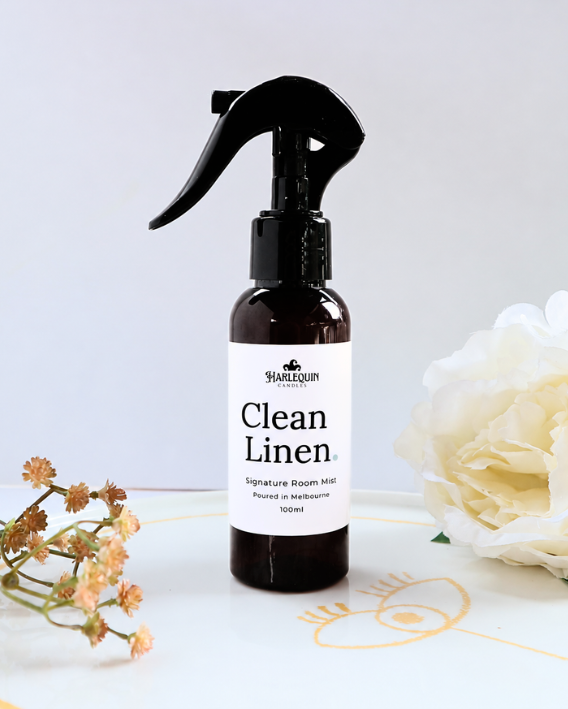 Clean Linen Room Mist by Harlequin Candles displayed with white flowers, a fresh home fragrance spray hand poured in Melbourne.