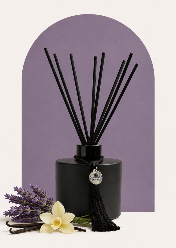 An Australian made Harlequin Candles black matte reed diffuser with a calming and relaxing fragrance of lavender and vanilla, set against a purple background with lavender sprigs.