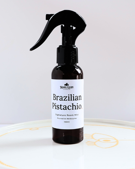 Harlequin Candles Brazilian Pistachio Bum Bum Type fragrance 100ml signature room mist in a premium amber spray bottle on a minimalist white ceramic tray, handmade in Melbourne Australia.