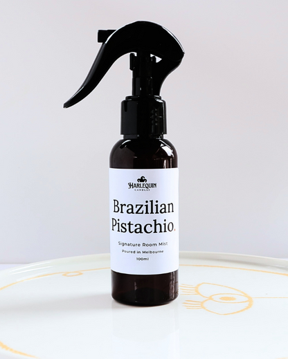 Harlequin Candles Brazilian Pistachio Bum Bum Type fragrance 100ml signature room mist in a premium amber spray bottle on a minimalist white ceramic tray, handmade in Melbourne Australia.
