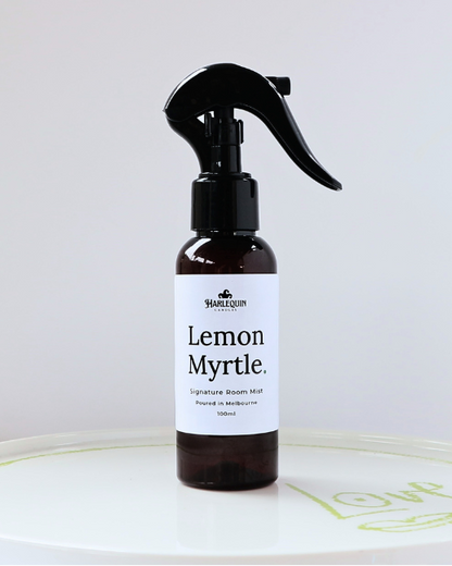 Harlequin Candles Lemon Myrtle 100ml signature room mist in a premium amber glass spray bottle on a minimalist white ceramic tray, hand-poured in Melbourne Australia.