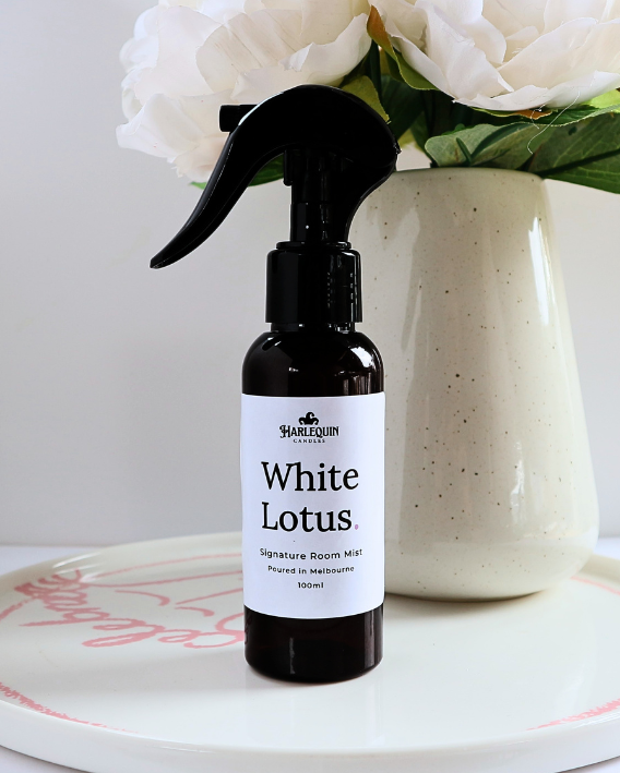 Luxury White Lotus home fragrance spray styled with white peony flowers in a ceramic vase, elegant floral room deodorizer by Harlequin Candles.