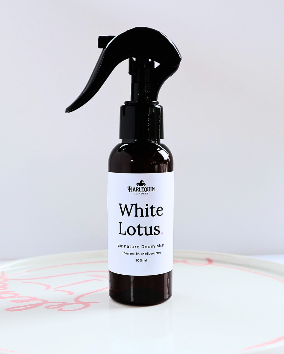 Harlequin Candles White Lotus 100ml signature room mist in an amber spray bottle on a white designer ceramic tray, hand-poured in Melbourne.